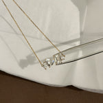 Multi Shape Diamond Necklace held with tweezers over linen, IGI Certified Lab Diamonds