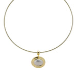 Oval Eclipse pendant on a thin gold cuff