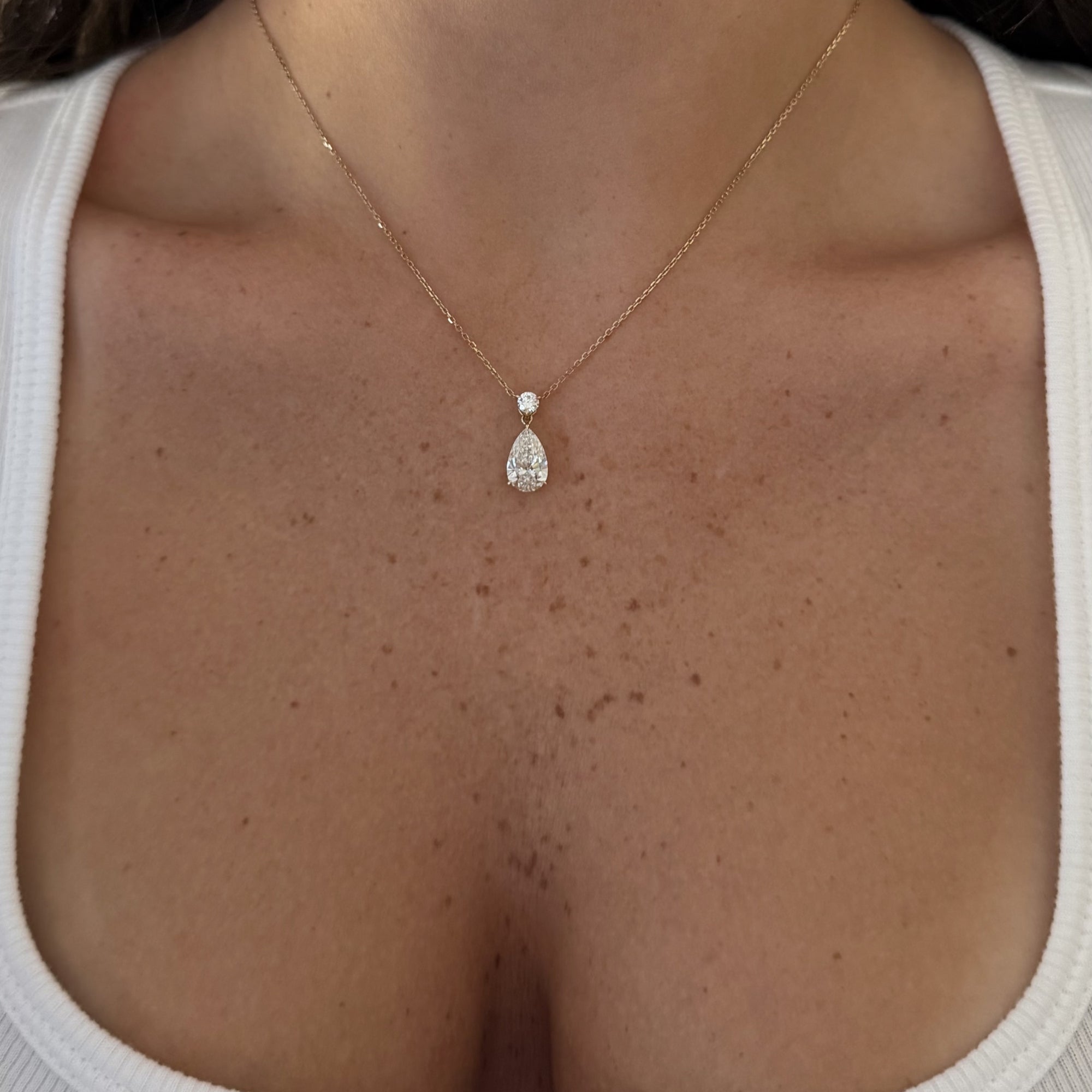 Pear Dangle Diamond Necklace worn on the neckline, 14K solid gold with an IGI Certified Lab Diamond