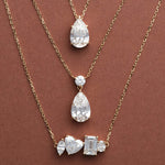 Pear Dangle, Classic Pear and Multi Shape Diamond Necklaces in 14K solid gold on a brown background