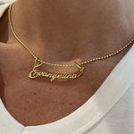 Close-up of the Signature Script Nameplate Charm spelling Evangelina