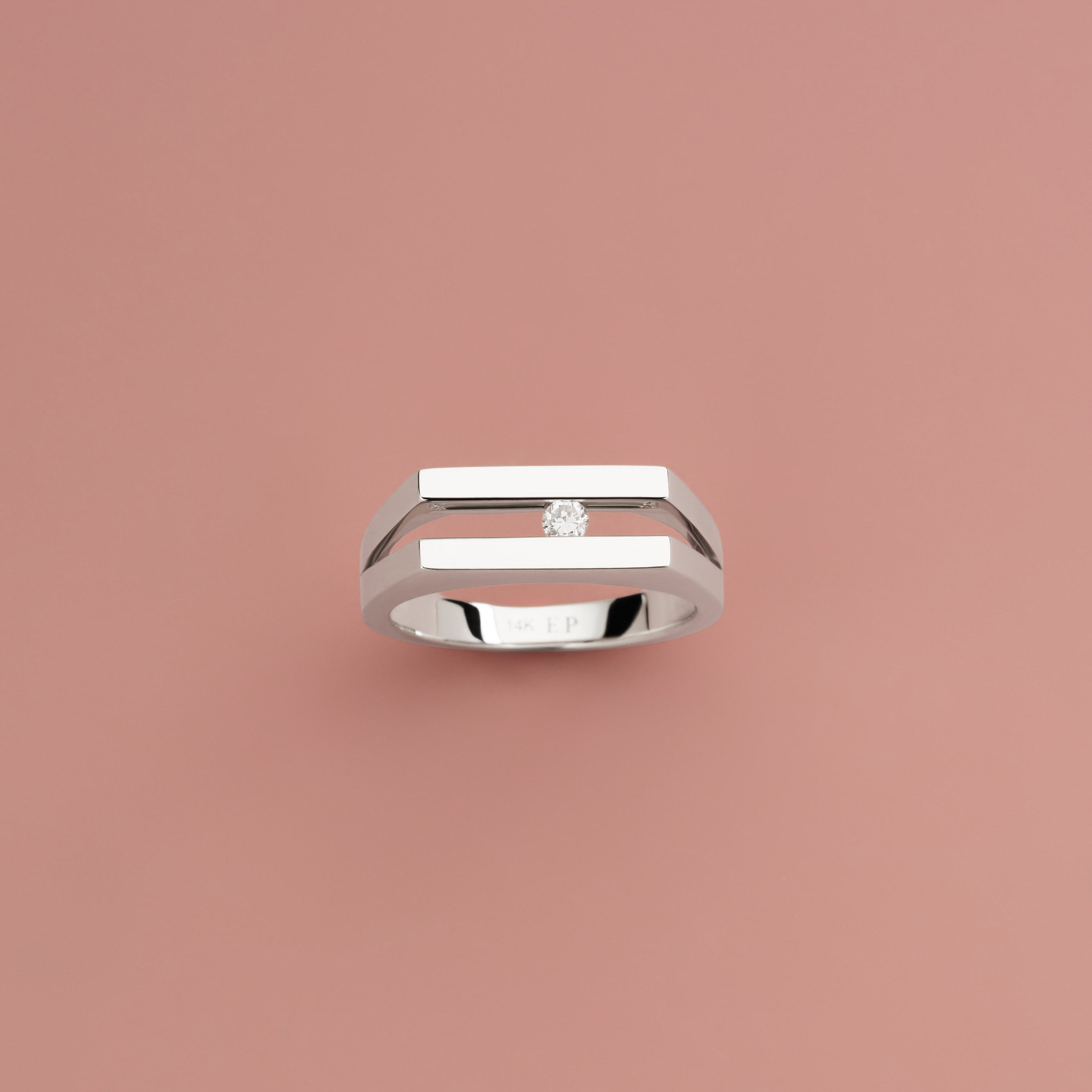 Slider Pinky Ring in 14K white gold with a lab-grown diamond on a pink background