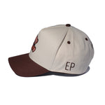 Side view of the Chocolate Brown EP Teddy Trucker Hat with EP embroidery