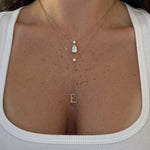 Timeless Lariat Letter Necklace with an E initial layered with a pear diamond necklace