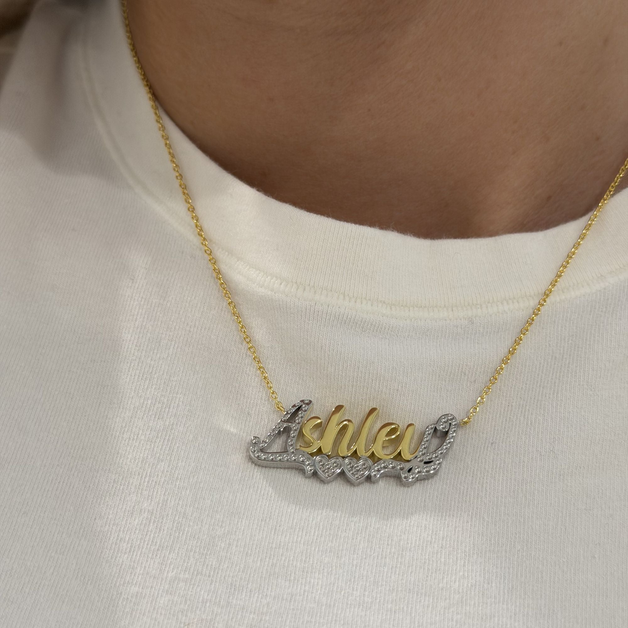 Close-up of the Two Tone Script Nameplate Necklace worn