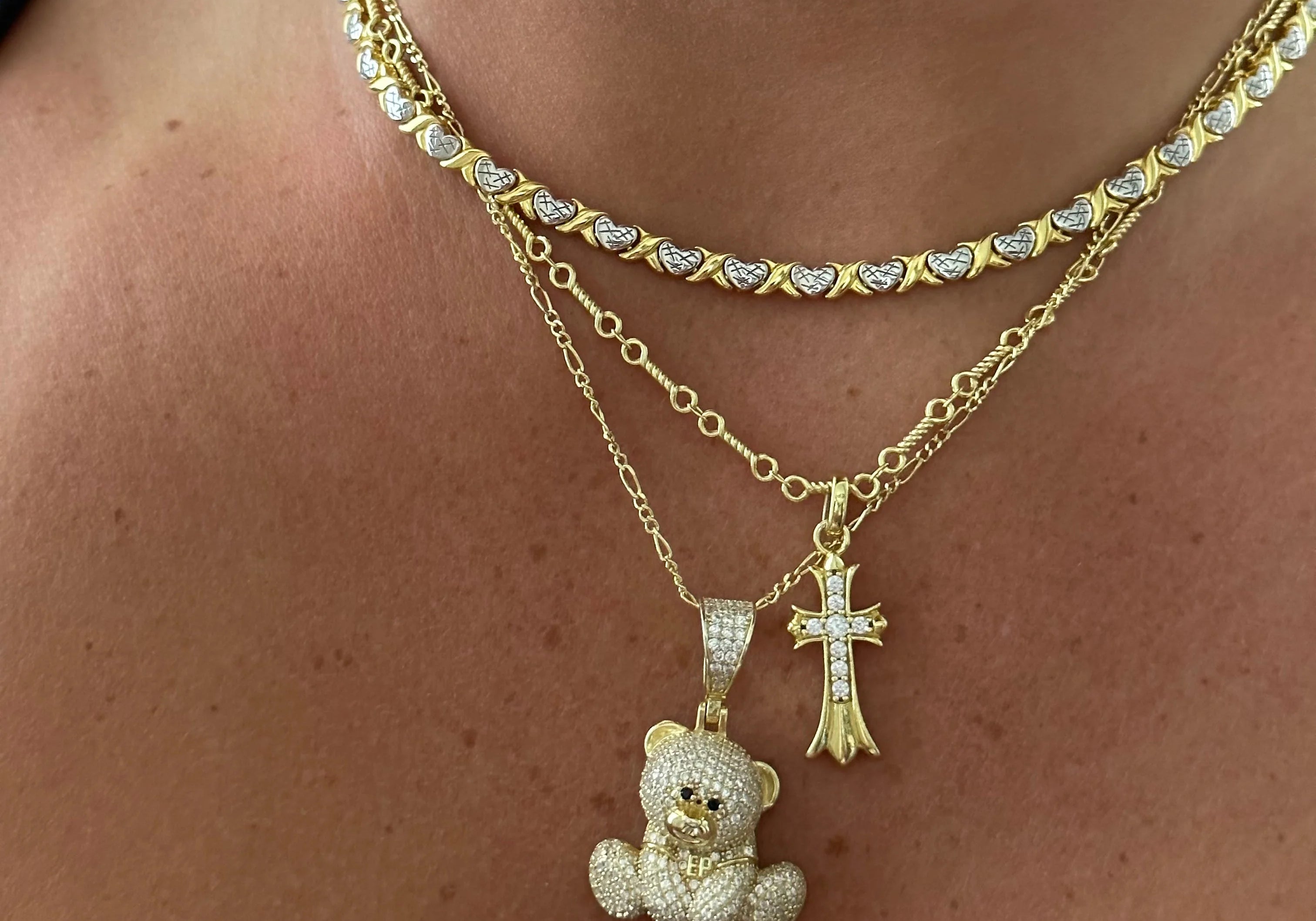 XOXO Necklace layered with a gold Iced EP Teddy Necklace and cross necklace