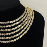 Stack of two-tone XOXO Necklaces layered on a black velvet bust