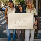 EP Jewels e-gift card in champagne with the ep jewels logo, held over three friends wearing EP Jewels necklaces