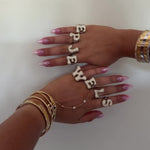 Video of Iced Jumbo Letter Rings spelling EP JEWELS across the fingers